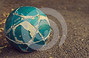 The old shabby soccerball on a dark background.