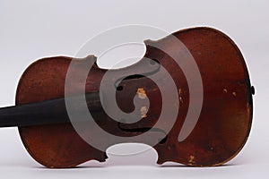 Old shabby violin body on white background