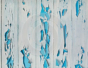 Old shabby wooden planks with cracked color paint, background. light blue