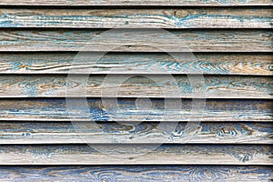 Old shabby wooden planks with painted blue peeled surface