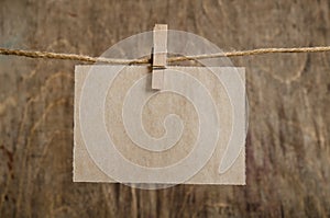 Old sheet of paper hanging on the clothesline on clothespin