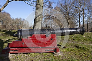 The old ship cannon with wooden carriage and black metal barrel