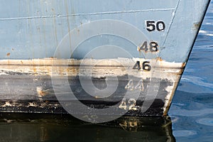 Old ship draft on hull, scale numbering. Distance between waterline and bottom keel