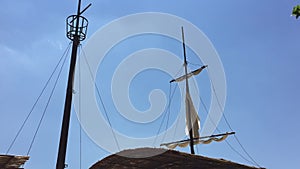 Old ship mast and sail swaying by wind. Concept sea pirat filibuster sky background.