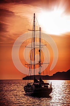 Old ship sailing to the sunset.