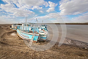 Old ships on the shore of a drying Amu Darya river, Uzbekistan photo