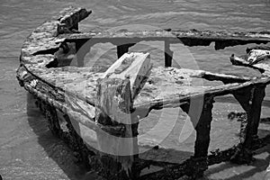 Old shipwreck, Galle Fort, Sri Lanka, Black and white image, rusted remains of fishing vessel on shoreline