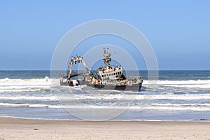 Old shipwreck Zeila at the Atlantic Coast between Swakopmund and Henties Bay along the famous Skeleton Coast in Namibia, Africa.