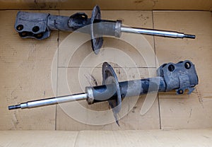 The old shock absorber in the crate box that was removed from a small sedan after being inspected