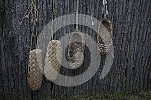 The old shoes hang on the fence and dried. Russian retro shoes. Shoes ancestors
