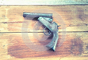 OLd short gun on the wooden board , Thailand hand made gun