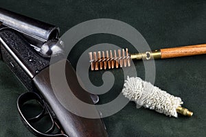 Old Shotgun on Outdoor Coat with Cleaning Equipment