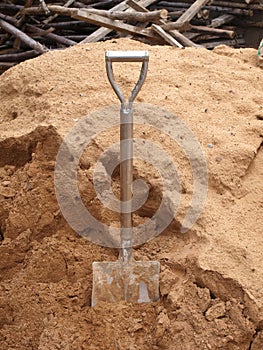 Old shovel dig in sand