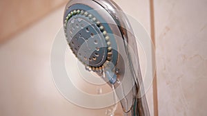 Old Shower Head with a Powerful Stream of Water Droplets Falling. Water Pressure