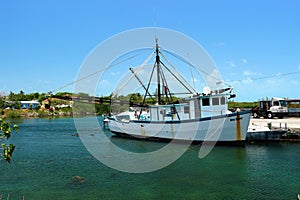 Old shrimper docked in Hatchet Bay Harbour Eleuthera Bahamas