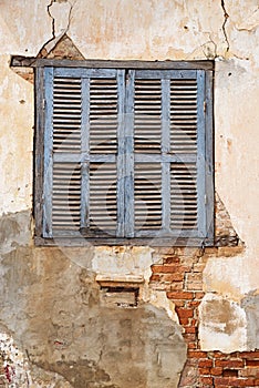 Old Shuttered Window In Cracked Peeling Wall photo