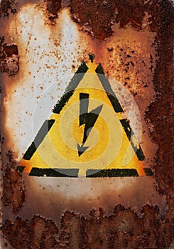 Old sign of danger of electric shock covered with rust