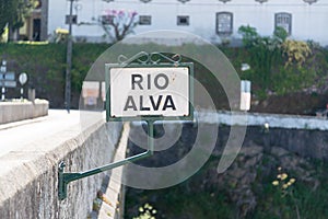 Old sign \'\'Rio Alva\'\' on a stone bridge in the historic town of Portugal called Coja photo