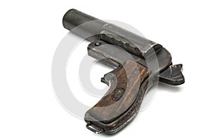 Old signal pistol, flare gun with the hammer cocked, isolated