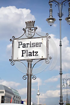 Old signboard with caption Pariser Platz written in old German font as a symbol of central Berlin