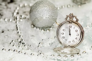 Old silver clock close to midnight and Christmas decorations