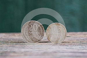 old silver coins stand on a gray table