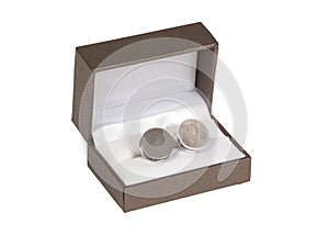 Old silver cufflinks in a box, on white background