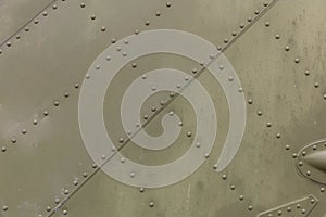 Old silver metal surface of the aircraft fuselage with rivets. Iron plate,steel sheet texture,pattern and background. Aluminum sur