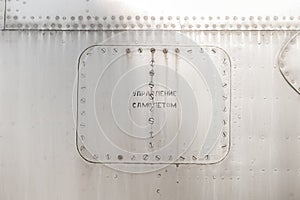 Old silver metal surface of the aircraft fuselage with rivets