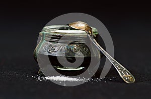 Old silver saltcellar on a black background photo