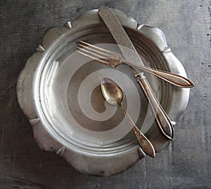 Old silverware on an old dish