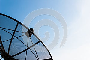 Old single satellite dish with twilight blue sky