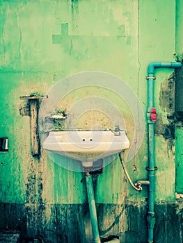 Old sink on a delapidated wall