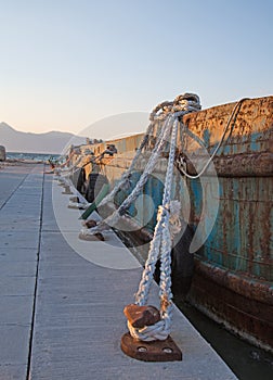 Old sisal ropes on a old rustic cargo boat in the port. photo