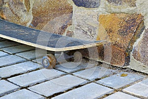 Old skateboard from a stone wall