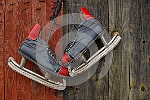 Old skates hang on the wooden door