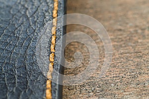 Old skin with a seam on a wooden surface macro