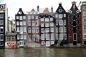 Old slanting canal buildings in Amsterdam photo