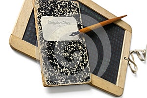 An old slate, penholder and exercise book, to learn write.