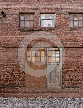 Old sliding barn doors on outside brick wall of old factory