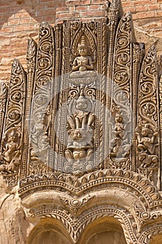 Old sloughing bas-relief with religious ornament on the facade o photo