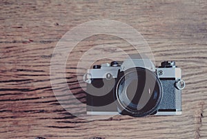 Old  SLR Film camera on wood background