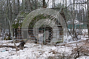 Old small abandoned and ruinous country house in russia.