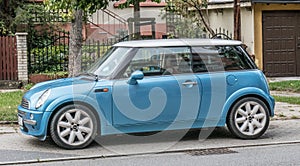 Old small blue car Mini Cooper parked left side view