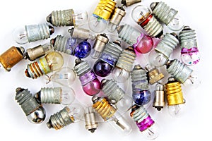 Old small colored light bulbs on a white background