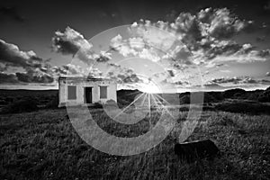 Old small deserted house in field with cloud sunset landscape ar