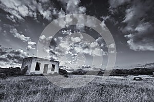 Old small deserted house in field with cloud sunset landscape ar