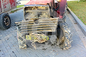 An old small tractor with a sad look