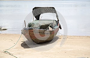 Old small wooden boat on beach
