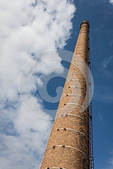 Old smokestack against blue sky